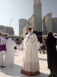 People standing in front of buildings against clear sky