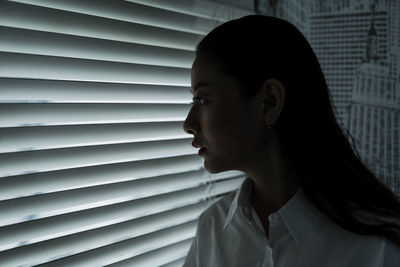 Close-up portrait of young woman against wall