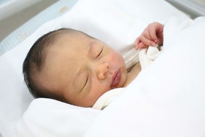 Cute baby sleeping on bed