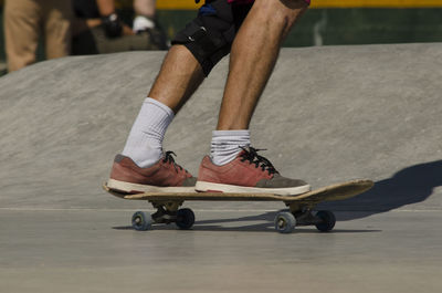 Low section of man skateboarding outdoors