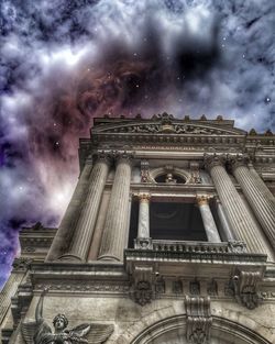 Low angle view of historical building against cloudy sky