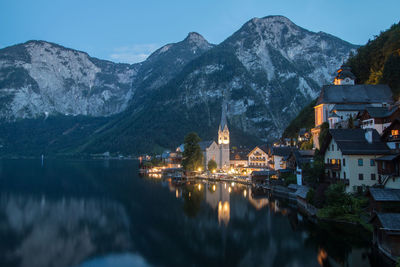 Panoramic view of illuminated buildings and mountains against sky