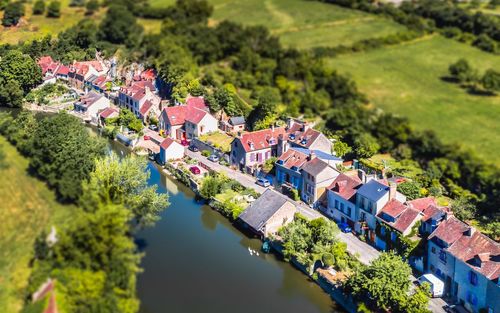 High angle view of houses by river in town