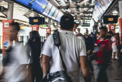 Rear view of people walking on train