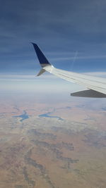 Airplane wing against sky