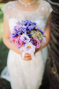 Close-up of woman holding bouquet