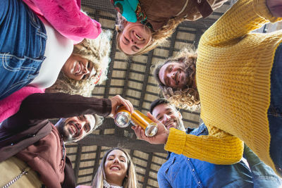 Directly below portrait of friends toasting drinks 