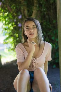 Portrait of young woman sitting outdoors