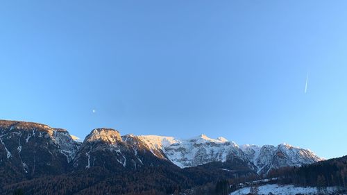 Scenic view of snowcapped mountains against clear blue sky