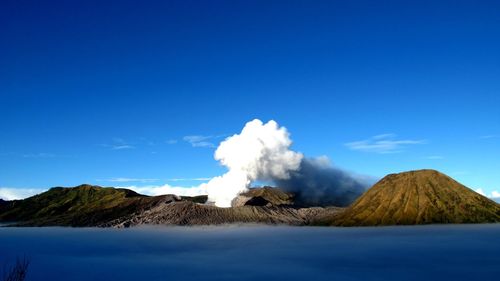 Scenic view of mountains against clear blue sky