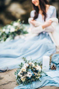 Close-up of woman holding white flower