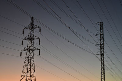 Low angle view of electricity pylon against sky