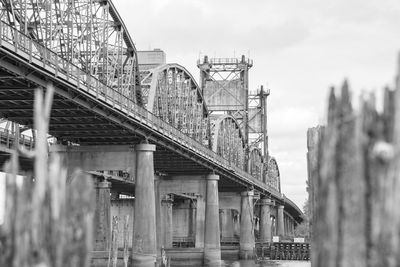 Low angle view of bridge in city against sky