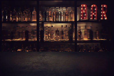 Illuminated bottles in city at night