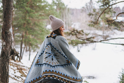 Midsection of woman on snow covered land