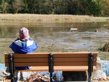 Rear view of man sitting in water