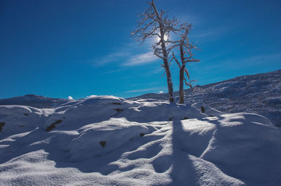 Scenic view of mountains against blue sky