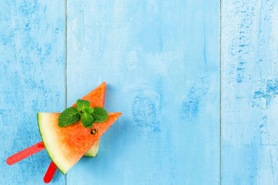 Close-up of orange slices against blue background