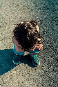 High angle view of boy standing on street