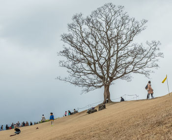 People standing on landscape against sky