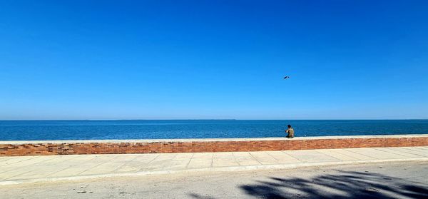 Scenic view of beach against clear blue sky