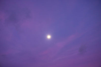 Low angle view of moon against sky at night