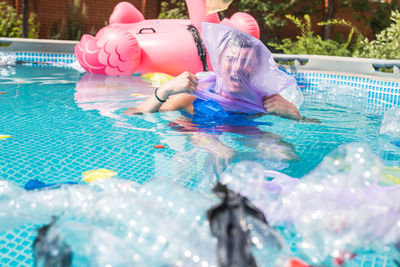 Reflection of people in swimming pool