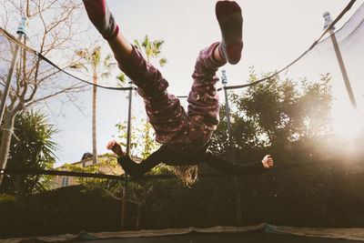 Full length of boy playing on trampoline