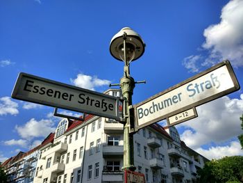 Low angle view of road sign against sky