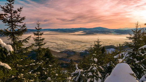 Scenic view of snowcapped mountains against sky during sunset