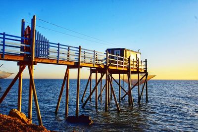 Lifeguard hut by sea against clear sky