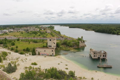 High angle view of houses by sea against sky