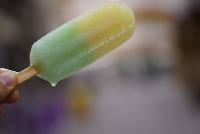 Close-up of hand holding ice cream