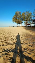 Shadow of man on sand