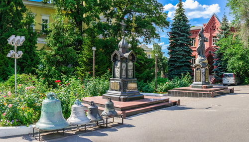 Statue against trees and plants in city