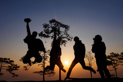 Silhouette man jumping against clear sky during sunset