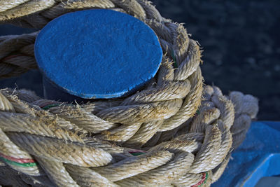 Close-up of rope tied on bollard