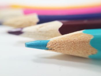 Close-up of colored pencils against white background