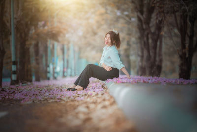 Side view of woman sitting outdoors