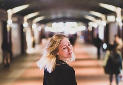 Portrait of woman standing at subway station