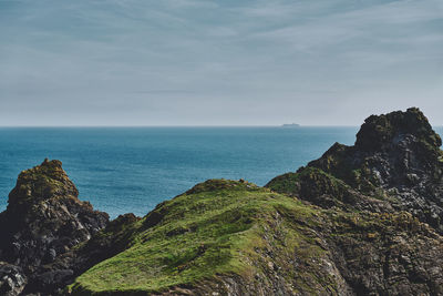 Scenic view of sea against sky at kynance cove in cornwall, england