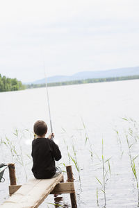 Boy on jetty fishing