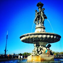 Statue of fountain against blue sky