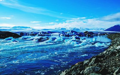 Scenic view of frozen river against sky