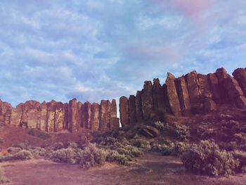 Rock formations on landscape against sky