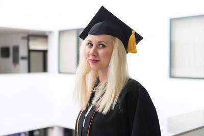 Young woman wearing graduation gown