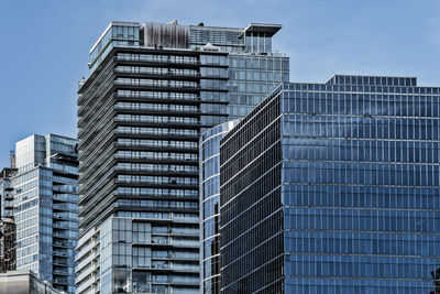 Low angle view of modern buildings against clear sky