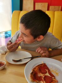 Portrait of boy eating food