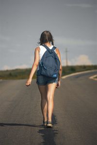 Full length of woman standing against sky