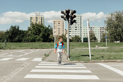 Boy crossing road in city